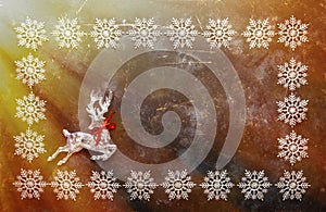 Christmas background with snowflakes and crystal deer. Top view with copy space