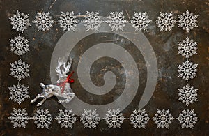 Christmas background with snowflakes and crystal deer. Top view with copy space