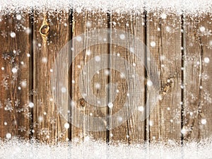 Christmas background with snowflakes on wooden board with snow in winter