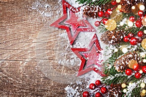 Christmas background with stars, snowy fir branches, cones and bokeh lights. Holiday banner