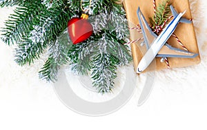 Christmas background on the theme of travel. The plane symbolizes the gift of the journey. Selective focus.