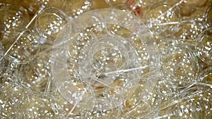 Christmas background with transparent glass balls lying in a box. Factory of Christmas toys, production of glass balls