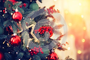 Christmas background tree New Yeae branch with decorations red balls gifts and star, with bokeh sun light