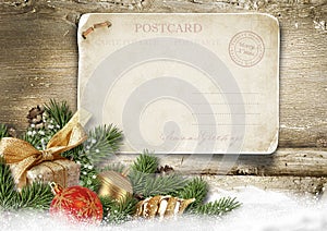 Christmas background with vintage postcard, ball, fir on wood