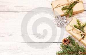 Christmas background and wallpaper. Happy New Year composition. Christmas gift, pine cones, fir branches on wooden white fllor