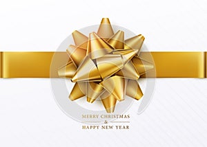 Christmas background. White gift box with golden bow and horizontal ribbon