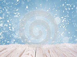 Christmas background with white wooden desk, covered by snow