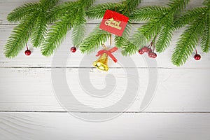 Christmas background wood composition fir branches and red berries / christmas decoration pine tree with bell festive xmas winter