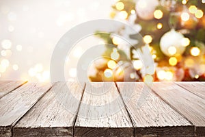 Christmas background. Wooden planks over blurred holiday tree lights