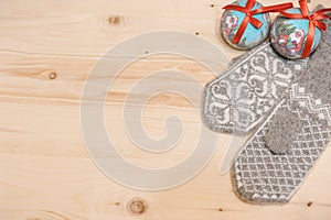 Christmas background. Woolen mittens on a wooden background