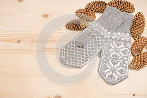 Christmas background. Woolen mittens on a wooden background