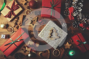 christmas background - wrapped gifts and decorations on wooden table