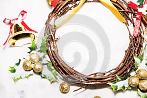 Christmas background, Wreath woven from the branch of the vine with golden bells and green leaf with golden ball