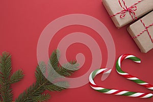 Christmas background with Xmas gifts, fir twings and candy canes. Top view, flat lay. Copy space for text
