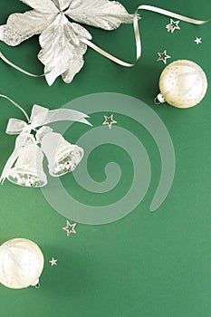 Christmas background. Xmas or new year white silver color decorations on green background with empty copy space for text.