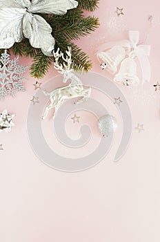 Christmas background. Xmas or new year white silver color decorations on pastel pink background with empty copy space for text.