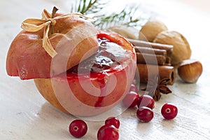 Christmas baked apple with cranberries, cinnamon and nuts, food christmas concept