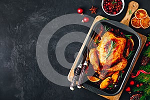 Christmas baked chicken or turkey with spices, oranges and cranberries