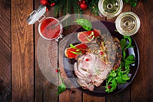 Christmas baked ham and red caviar, served on the old wooden table.