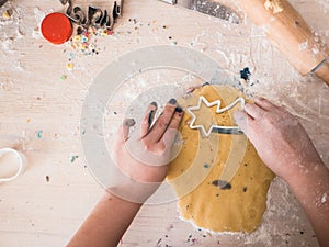 Christmas Bakery: Little girl cutting out dough for christmas cookies