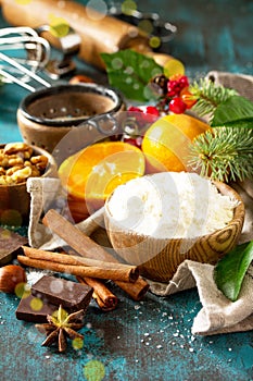Christmas Baking background. Ingredients for Christmas baking - chocolate, cinnamon, flour, sugar, nuts, chocolate, spices