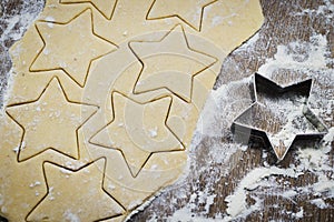 Christmas baking. Making gingerbread biscuits. Cookie dough and cookie cutters on kitchen counter.