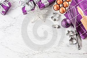 Christmas baking purple gifts decorations eggs and kitchen utensil on marble table