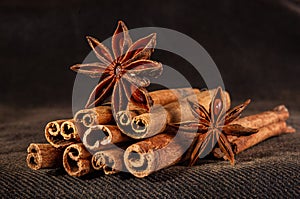 Christmas baking spices, cinnamon sticks and anise stars for Christmas cake, cookies or mulled wine on a black