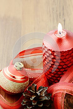 Christmas ball with buring candle and red ribbon