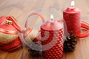 Christmas ball with buring candle and red ribbon