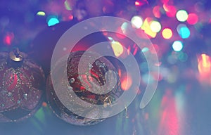 Christmas ball close-up on the background of the lights garland blurred purple and blue background.