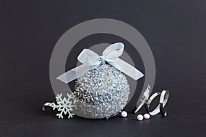 Christmas ball on colored background. decoration bauble with ribbon bow with copy space