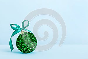 Christmas ball on colored background. decoration bauble with ribbon bow with copy space