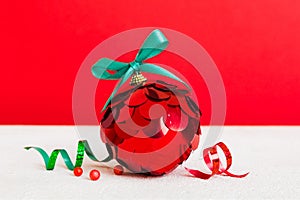 Christmas ball on colored background. decoration bauble with ribbon bow with copy space