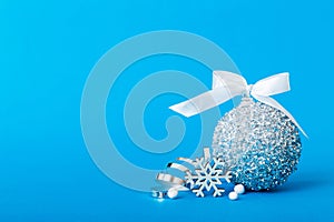 Christmas ball on colored background. decoration bauble with ribbon bow with copy space