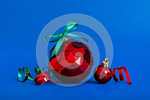 Christmas ball on colored background. decoration bauble with ribbon bow with copy space