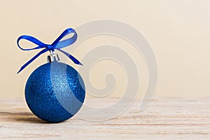 Christmas ball on colored background. decoration bauble with ribbon bow with copy space