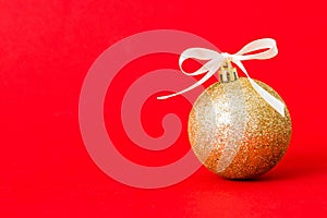 Christmas ball on colored background. decoration bauble with ribbon bow with copy space