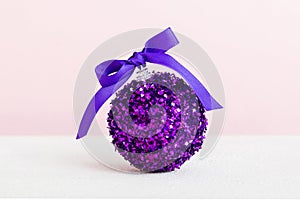 Christmas ball on colored background. decoration bauble with ribbon bow with copy space