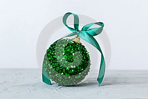 Christmas ball on colored background. decoration bauble with ribbon bow with copy space