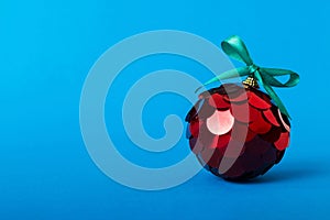 Christmas ball on colored background. decoration bauble with ribbon bow with copy space