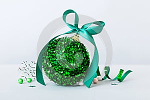 Christmas ball on colored background. decoration bauble with ribbon bow with copy space