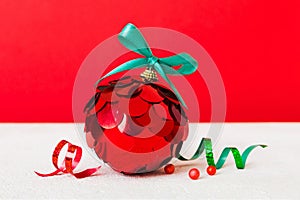 Christmas ball on colored background. decoration bauble with ribbon bow with copy space