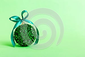 Christmas ball on colored background. decoration bauble with ribbon bow with copy space