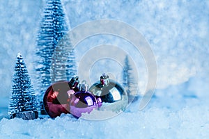 Christmas ball decor with pine tree on snow