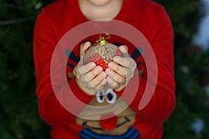 Christmas ball decoration in child hands