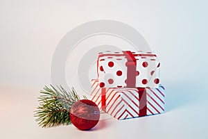 Christmas ball, gifts and green spruce branches on a white background. Holidays christmas background. Copy space for text or