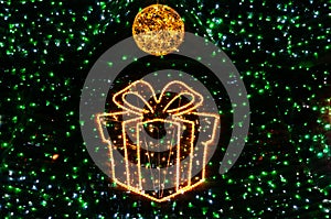 Christmas ball on glowing sparkling background with green fluorescent backdrops