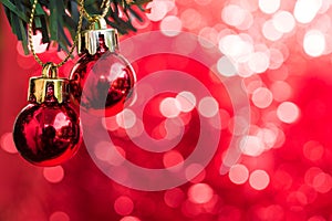 Christmas ball ornament decorate on fir tree with red bokeh