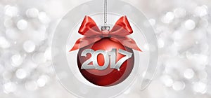 Christmas ball with red satin ribbon bow and 2017 text on silver